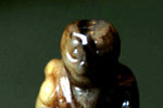Pendant in the form of a squatting monster holding a flywisk and a rosary