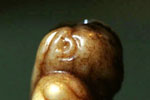 Pendant in the form of a squatting monster holding a flywisk and a rosary