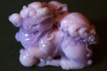 Buddhist lion-dog with left forepaw on a ball